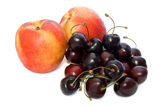 two nectarines and cherries isolated on white background
