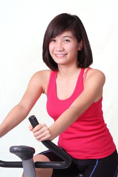 a young lady exercising on a stationary bike
