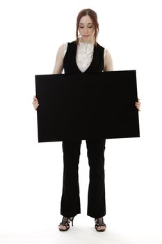 Young business woman wearing a business suit holding a black board against white background