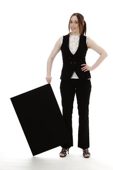 Young business woman wearing a business suit holding a black board by the corner against white background