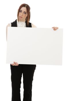 Young business woman wearing a business suit with a sad expression holding a white board against white background