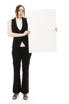 Young business woman wearing a business suit with a surprise expression holding a white board against white background