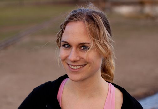 A cute runner is posing before she is off for a run.