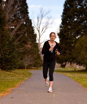 A cute runner is jogging towards the viewer.  Room For Text.