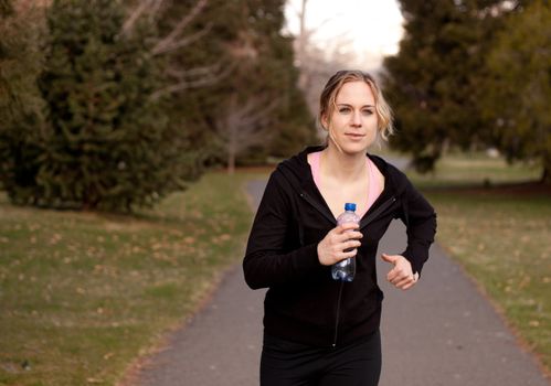 A sexy runner is running towards the viewer.