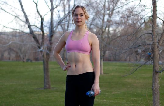 A beautiful young lady is getting ready for a jog.