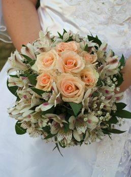 wedding bouquet with roses in bride's hands