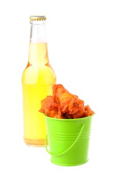 Small green bucket filled with spicy chicken wings.