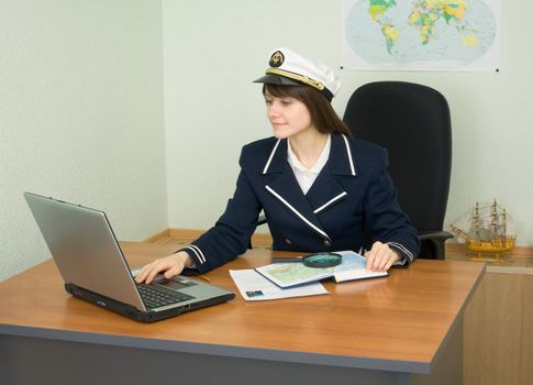 The girl at office of travel company with the laptop
