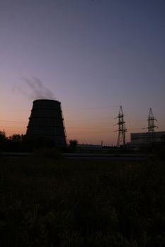 Power station over orange and blue sky