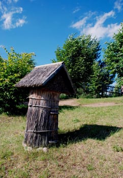 Ancient bee hive with reed covered roof and walls. Beekeeping museum.