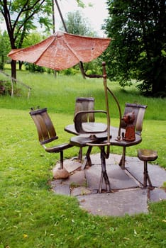 Original table and chairs with little roof. Rest in garden.