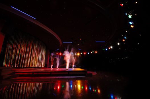 Dancers in a nightclub. Note that the dancers are in motion blur