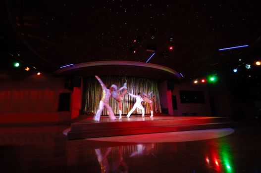 Dancers in a nightclub. Note that the dancers are in motion blur