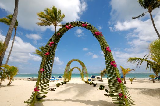 Wedding archway on tropical beach.