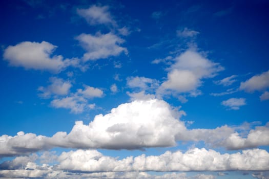 White cumulus clouds and blue sky.