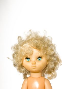 Vintage doll head with blue eyes and shock on a white background