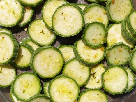 Green courgettes or zucchini vegetables useful as a background