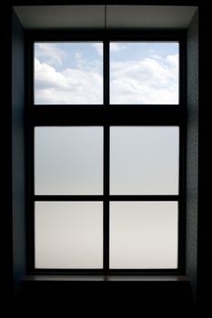 Interior view of a modern window that has frosted glass on the lower panes.