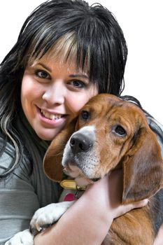 A pretty young woman posing with her beagle pup.  Shallow depth of field.