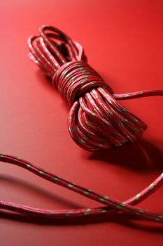 Red thread spool on monochrome background