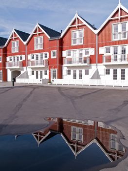 Modern classical design beach summer houses reflected perfectly in a small water pond