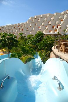 Water slide and hotel in the background.