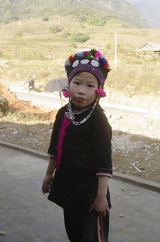 Black is also the color of clothing for children. This little boyl is wearing a cap embroidered with multicolored wool tassels.
