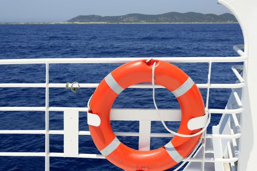 Cruise white boat handrail detail in blue sea and round orange buoy