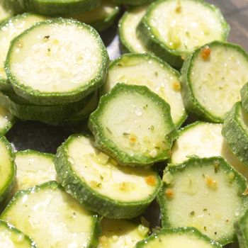 Green courgettes or zucchini vegetables useful as a background