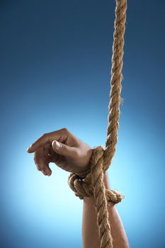 hand being tight by rope asking for help