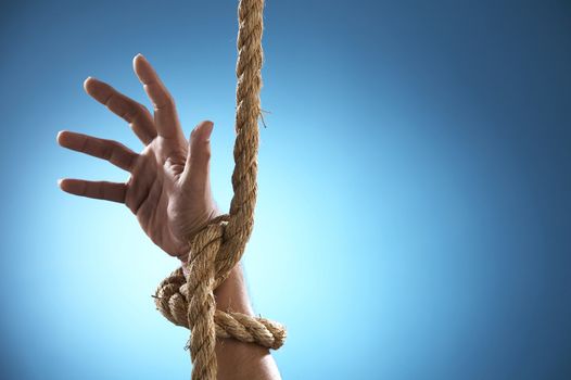 hand being tight by rope asking for help