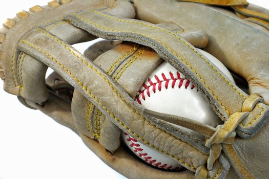 A baseballs nestled into a worn glove