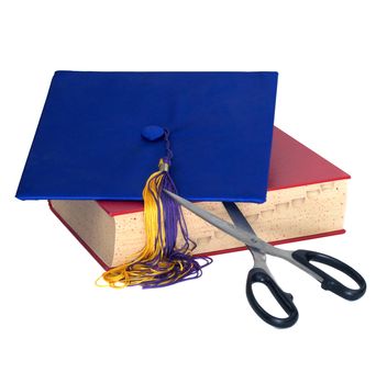 Scissors cutting a graduation hat and book to symbolize cuts to education.