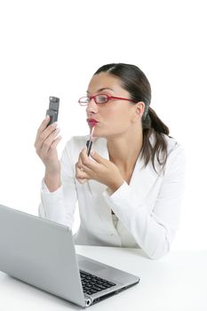 Businesswoman with red lipstick using mobile phone as a mirror
