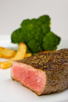 grilled steak on a plate with fries