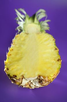 Pineapple with selective focus over purple background