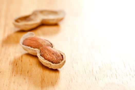 Peanuts on Wood Background with Dramatic Lighting.