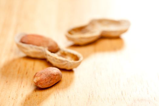 Peanuts on Wood Background with Dramatic Lighting.
