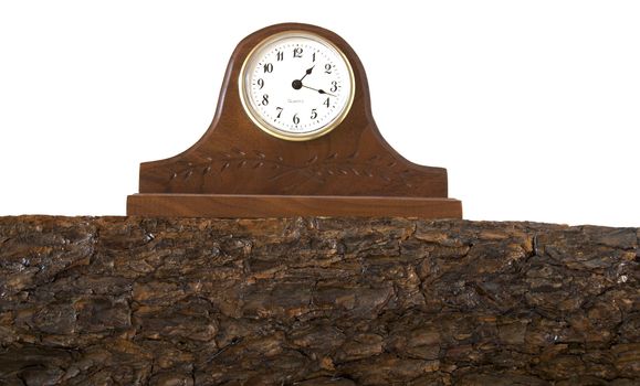 A clock sits on top of a hand cut pine mantle.