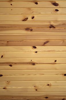 Horizontal background texture of knotty pine boards.