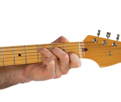Demonstration of how to play a C chord on the guitar