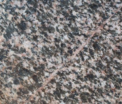 Macro of a piece of granite with a marble vane.