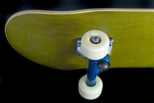 underside of a skateboard deck with blue metallic trucks