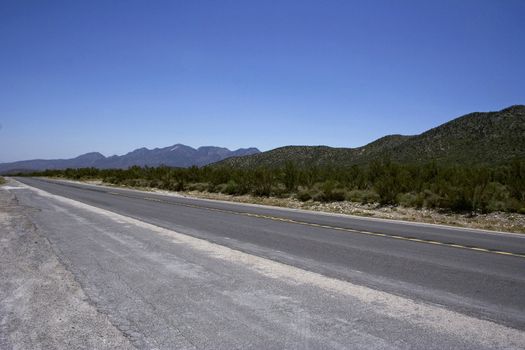 Conceprual photo of freeway with the mountains on a horizon
