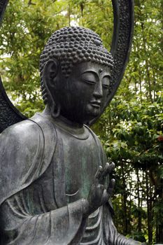 The sculpture of Buddha in a japanese garden