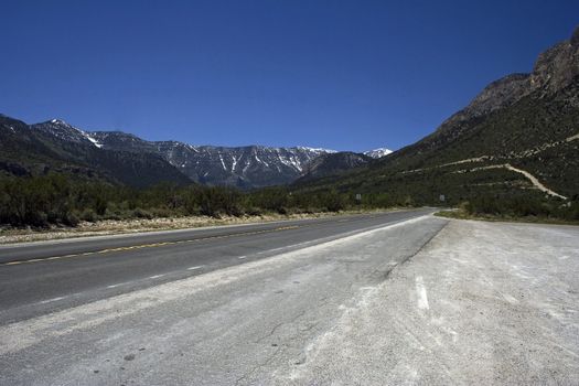 Romantic picture of an empty freeway with the mountains on a horizon