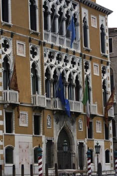 Romantic medieval building with flags in Venice