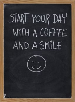 start your day with a coffee and a smile - invitation or advertisement handwritten with white chalk on blackboard