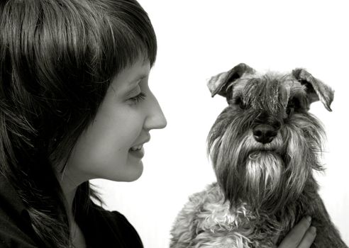 Happy owner with her pet schnauzer isolated on white